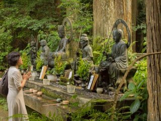 A lady praying in front of the Jizobosatsu statue at the base of Kami-Daigo in Kyoto!