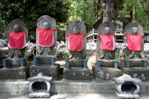 Jizo bosatsu statues line the entrance to the cemetery.