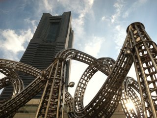 A roller coaster structure in front of Landmark Tower
