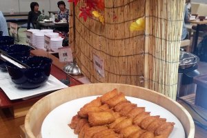 A fall display behind the inarizushi (fried tofu skin stuffed with vinegar rice)