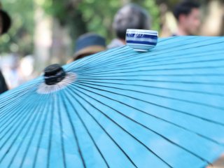 Sake cup in motion being balanced on Umbrella