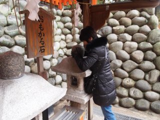 At Fushimi Inari Shrine. Think how much the stone weighs - if it feels lighter than you thought, your wish will come true