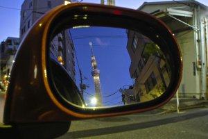 Reflection in a car&#39;s side mirror in the bylanes of Oshiage