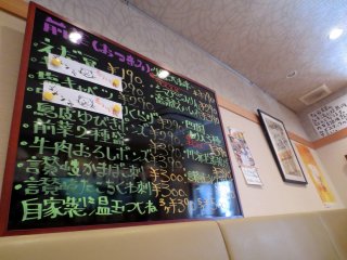 Colorful and fun handwritten menus and promotions on the walls of the restaurant