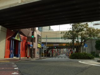 A view under the rail tracks; the road leads to Matsukage-cho