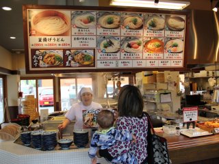 The menu board and display placards are strictly in Japanese, but there is a laminated flyer available that shows all offerings with descriptions in English and Korean