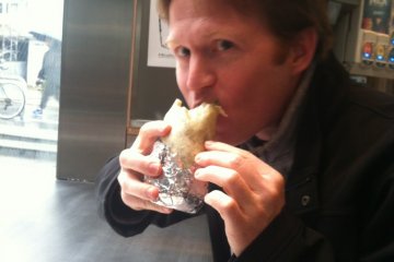 Regular customer digs into yet another carnitas fajita burrito
