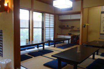 <p>The back room with small tables on tatami floor looking out into an outside garden</p>