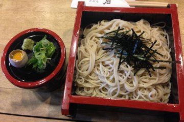 <p>Buckwheat soba topped with shredded seaweed, green onion garnish and yes, a raw quail egg. What a find!</p>