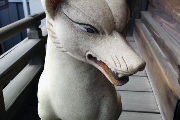A fox statue guards an Inari Shrine alongside the main shrine.&nbsp;