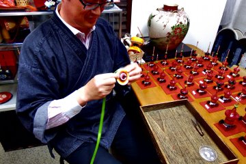 <p>The Maestro, Mr. Yoshiyuki Nakamura, is the only one in the world who inherited this traditional artisanship of Kyo Koma (Kyoto Spinning Tops)</p>