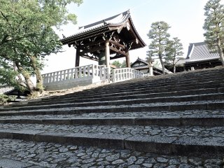 Climbing the stone steps to hall and temple bell (on the left)