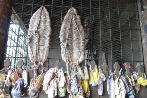 Different sizes of traditional sandals hanging at the gate