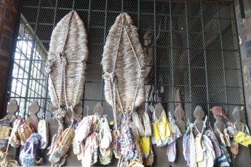 <p>Different sizes of traditional sandals hanging at the gate</p>