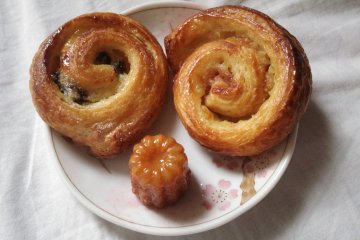 <p>Delicious raisin pastry with patisserie custard, cinnamon roll and a canele</p>