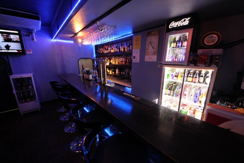 The relaxed atmosphere of Stickers bar showing selection of beverages and flat screen television.