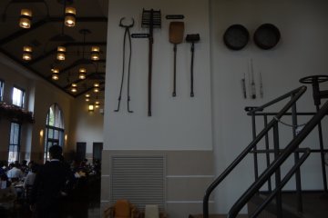 There are some instruments on the wall used to mix malt and to check the temperature.