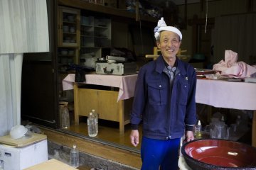 <p>Mr Kato in his soba-making space, with his 20-year old konehachi&nbsp;(soba-making&nbsp;bowl)</p>