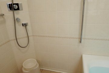 <p>Bathroom has a shower on the side with wash bowl and small chair. Japanese style!</p>