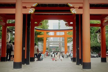 <p>Heading out of the shrine, groups of young japanese tourists are posing with the shrine.&nbsp;</p>