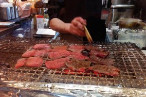 A chef grills the meat over charcoal&nbsp;