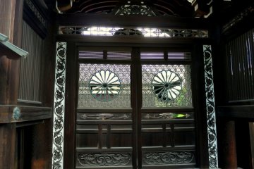 <p>Exquisite decorative screen on these wooden doors</p>