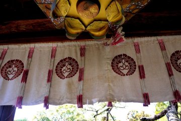 <p>Metal lantern and curtains hanging in the gate</p>