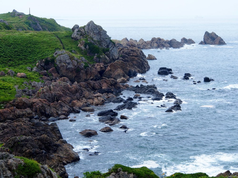 From the lookout, you can see the rugged, rocky coastline