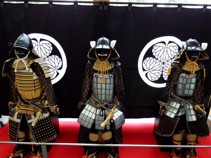 <p>Three armor-clad dolls of samurai are displayed in the museum lobby</p>