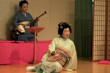 <p>The dancer, Ms. Shiori, lying on the stage in a sensuous pose</p>