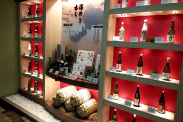 <p>Bottles of local Fukui sake adorn the hotel corridor</p>