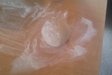 <p>After a bit of kneading you can turn your ball of dough out onto the table.</p>