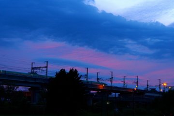 <p>Pink clouds over the JR Tohoku Shinkansen, pulling out of Morioka Station</p>
