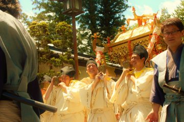 <p>Bearers of one of the three omikoshi or portable shrines that are seen in the procession. This one bears a phoenix, which represents the living spirit of the deified Tokugawa Iyasu.</p>