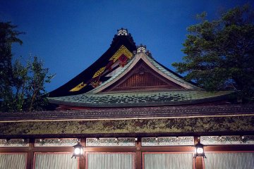 <p>The crests of two buildings in the shrine complex stand in contrast against the cool-lit sky</p>