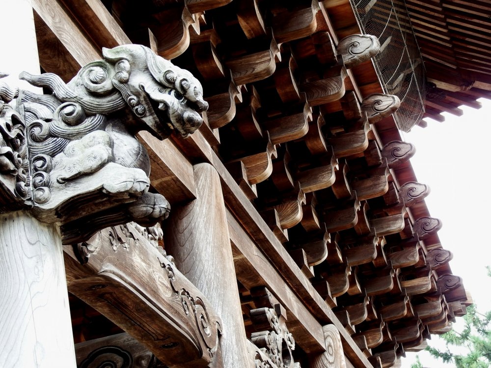 Beautiful wooden architecture, and a guardian dog carving