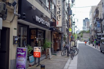 <p>The Words Cafe shopfront on the street, with the entrance to Osaka Tenmangu Shrine in the background</p>