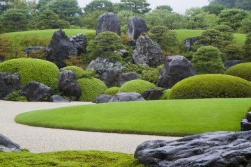 <p>Summer view of the Dry Landscape Garden, anchored by massive stones</p>