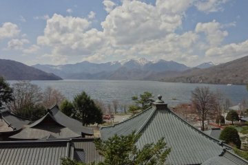 Over the black tiled roof of the temple buildings, you can see Chuzen-ji Lake and the elegant lower south slope of Mt. Nantai.