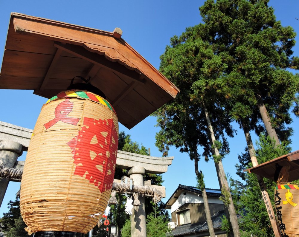 Brilliant orange lantern at Maki Shrine under the blue sky