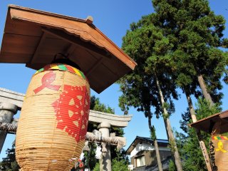 Brilliant orange lantern at Maki Shrine under the blue sky