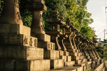 Похожие каменные статуи стоят в ряд перед храмовым комплексом.