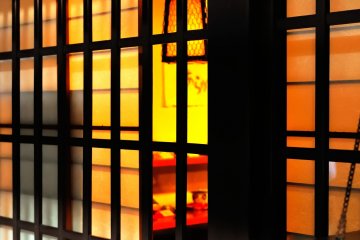 <p>Walking on an old street of Sanno Machi. Warm light is filtering through the lattice window of a souvenir shop.</p>