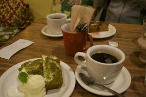 Green tea cake with cream cheese, ice cream and whipped cream, apple cake and organic filtered coffee