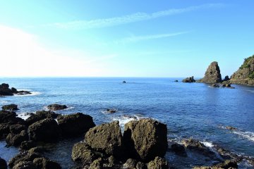 <p>Rocky shore of Echizen Beach under the blue sky</p>