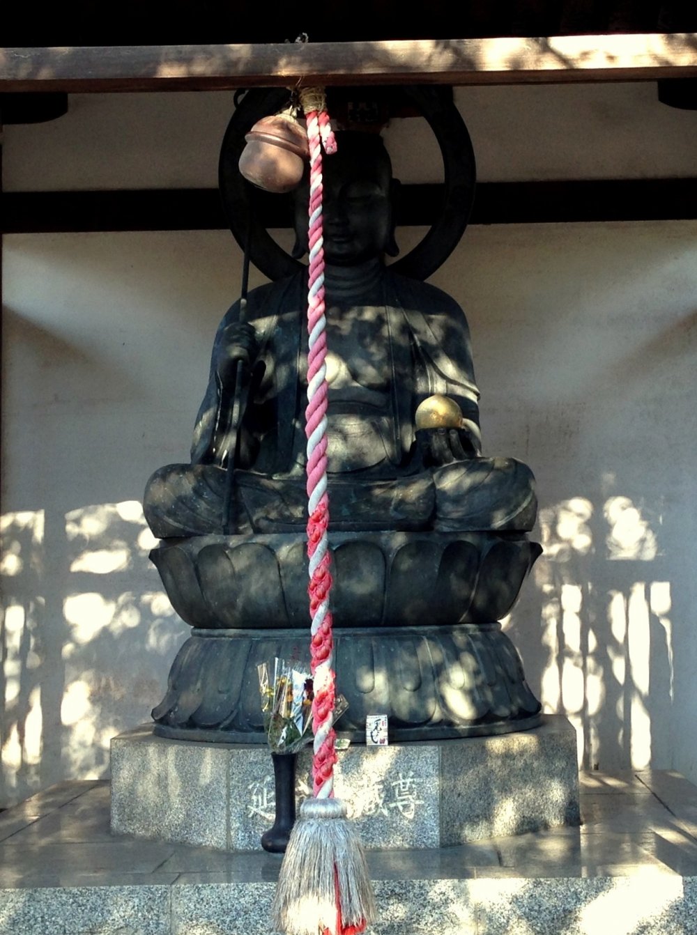 Buddha and bell rope