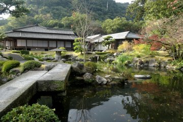 <p>On the hill, you can just make out white kanji painted on the rock, an unusual feature for a Japanese garden</p>