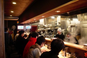 <p>Customers sit down in front of the cooks and watch the magic happen.</p>