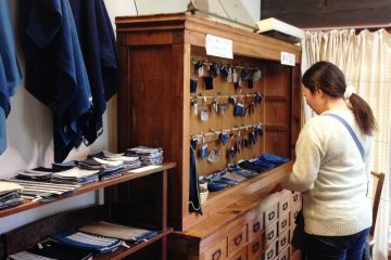 <p>Take a look at the various indigo textiles for sale at the counter.</p>