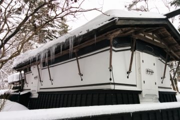 Icicles hang off the eaves of the roof